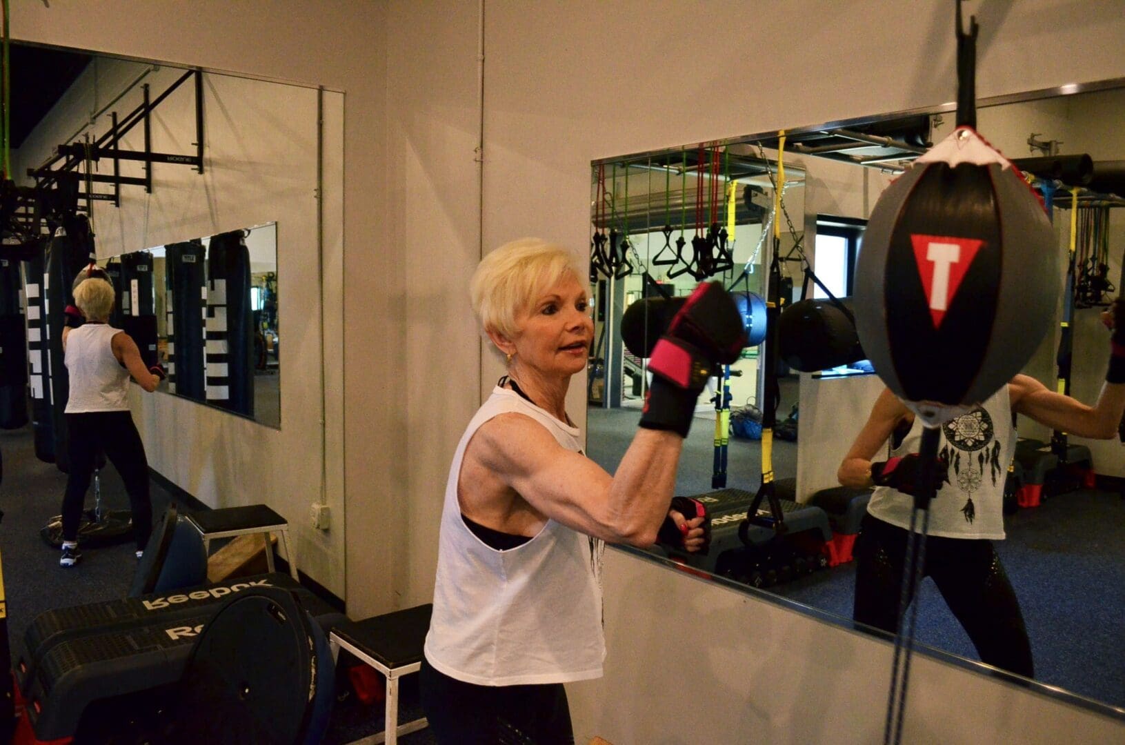 A woman is boxing in the gym